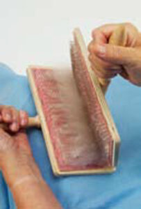 person transferring fiber between carders